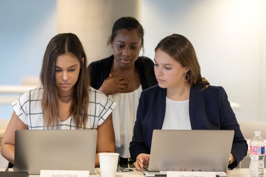 Three women working on laptops. 